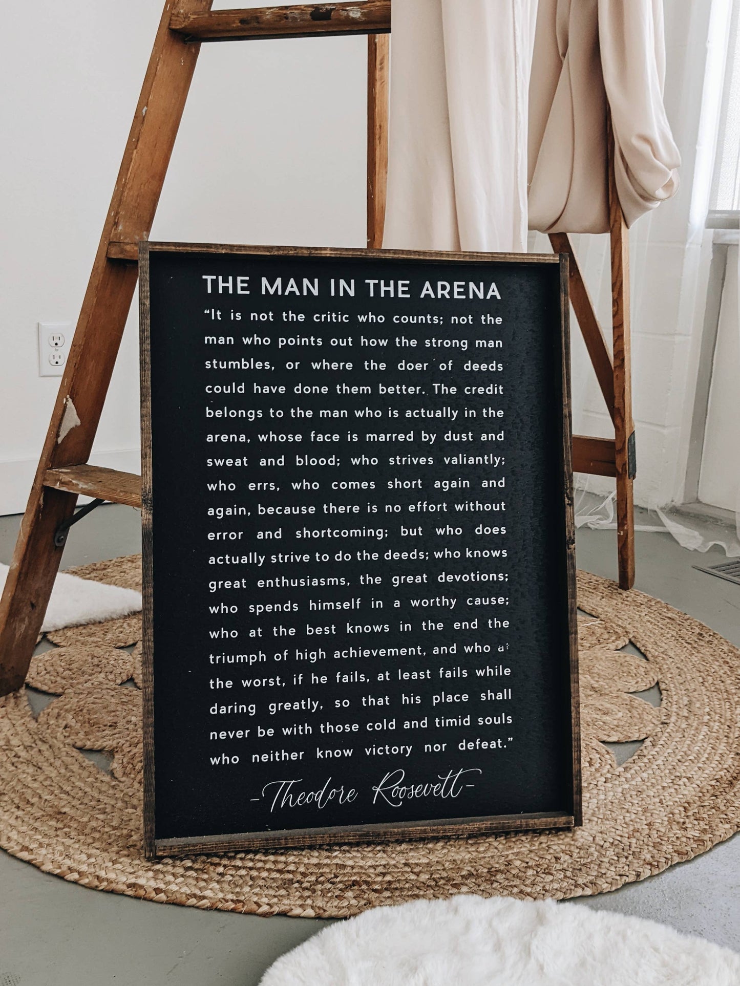 The Man in the Arena Wood Sign: White / 18” x 24”.