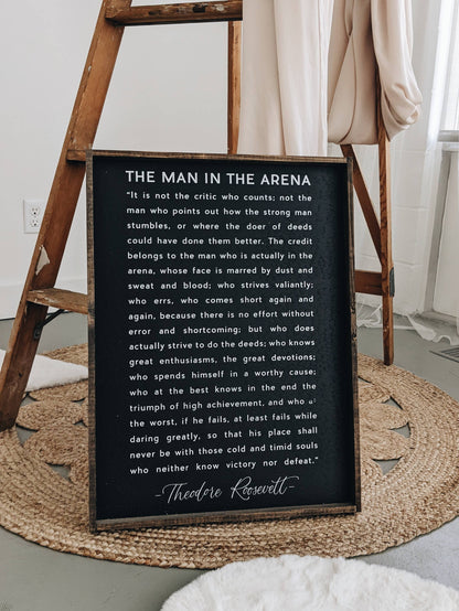 The Man in the Arena Wood Sign: White / 18” x 24”.